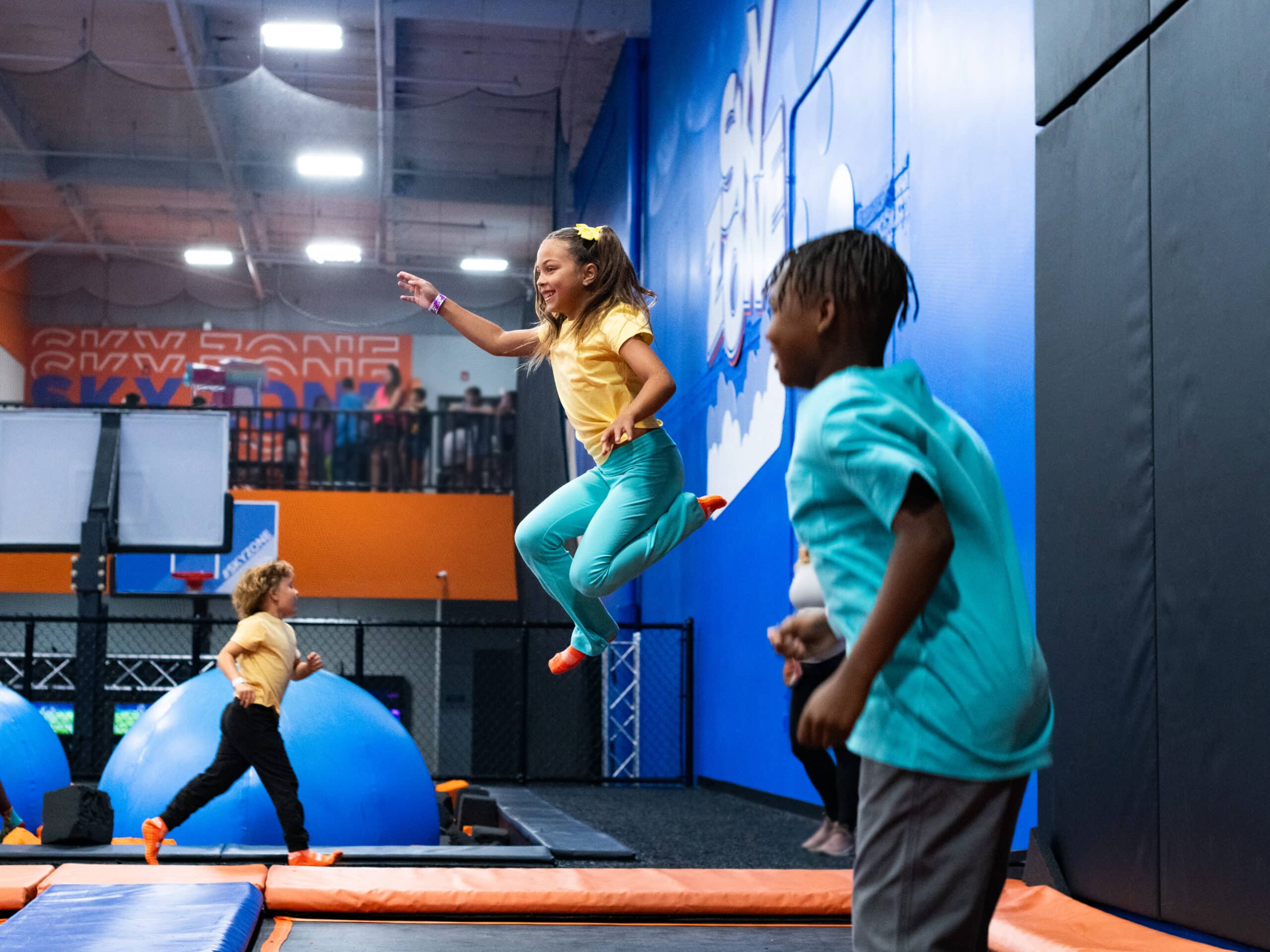 Kids jumping on a trampoline at an indoor playground